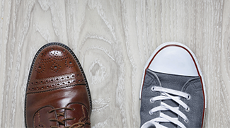 Work Life Balance shown by ariel view of business shoe and sneaker